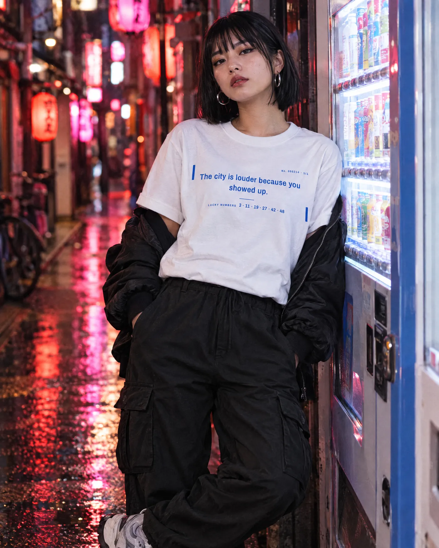 Woman in the Fortune Cookie Shirt leaning on a vending machine in a neon-lit Tokyo alley at night